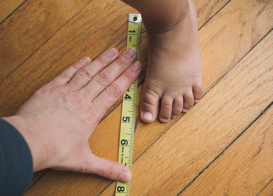 measuring a foot with tape measurer